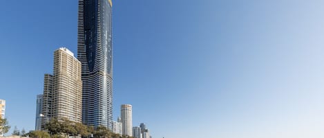 A beach with high-rise buildings in the background.