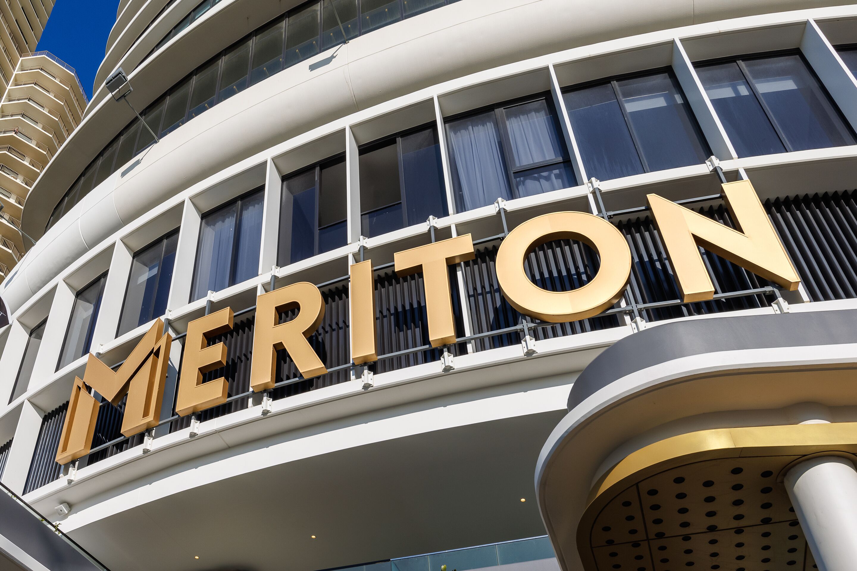 A hotel with a prominent 'MERITON' sign on the exterior.