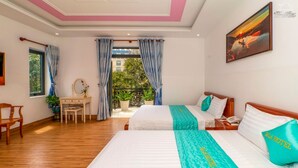 A hotel room with two beds, a desk, a chair, and a balcony with curtains. - Sala Hotel (Ho Chi Minh City)