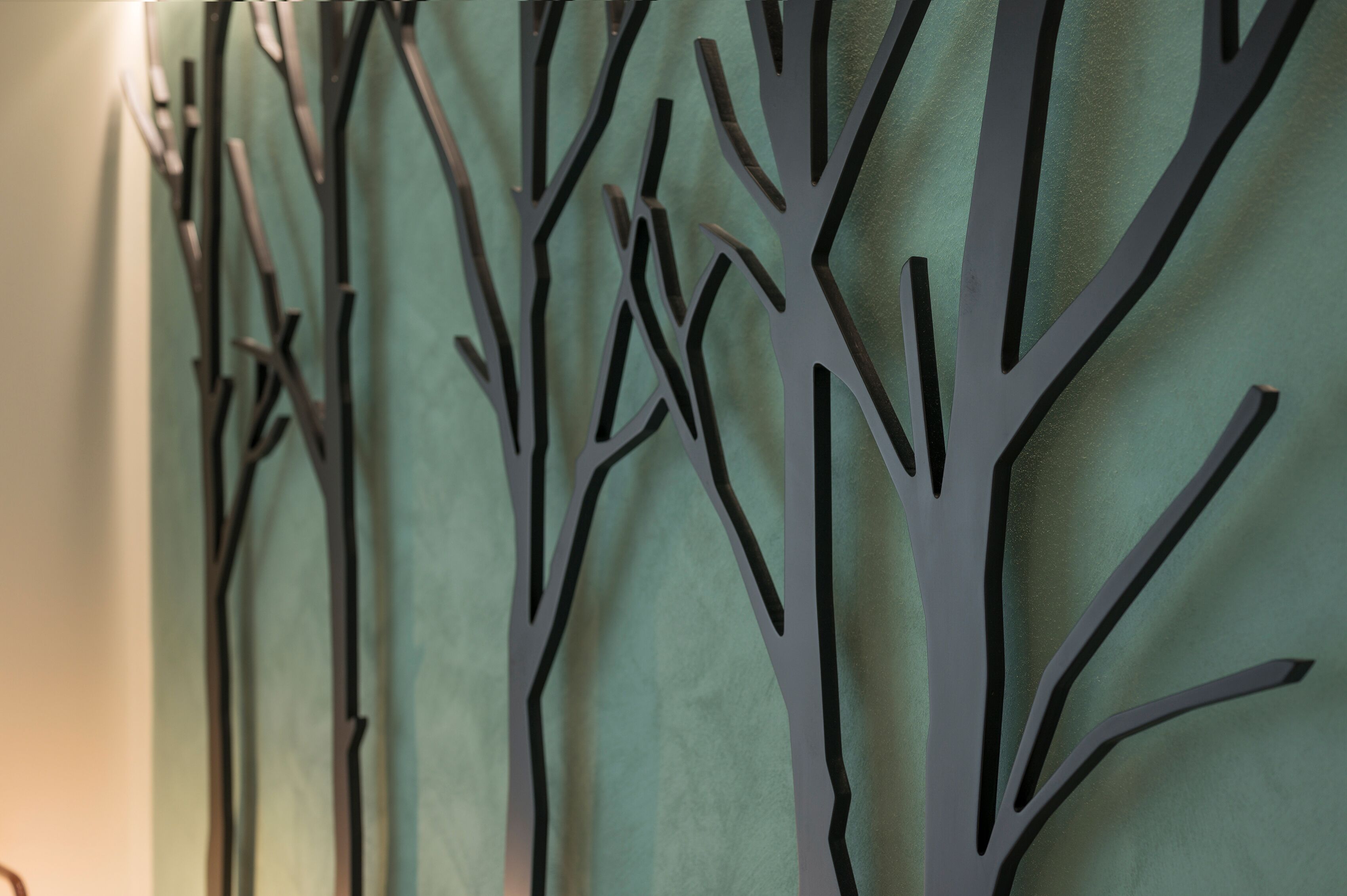 A wall with a geometric tree design.