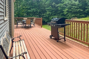 Enjoy al fresco dining and relaxation on this tranquil outdoor space with a grill station and seating area.