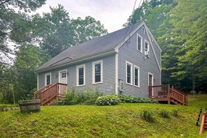 Stunning two-story house with a central entrance and inviting front porch.