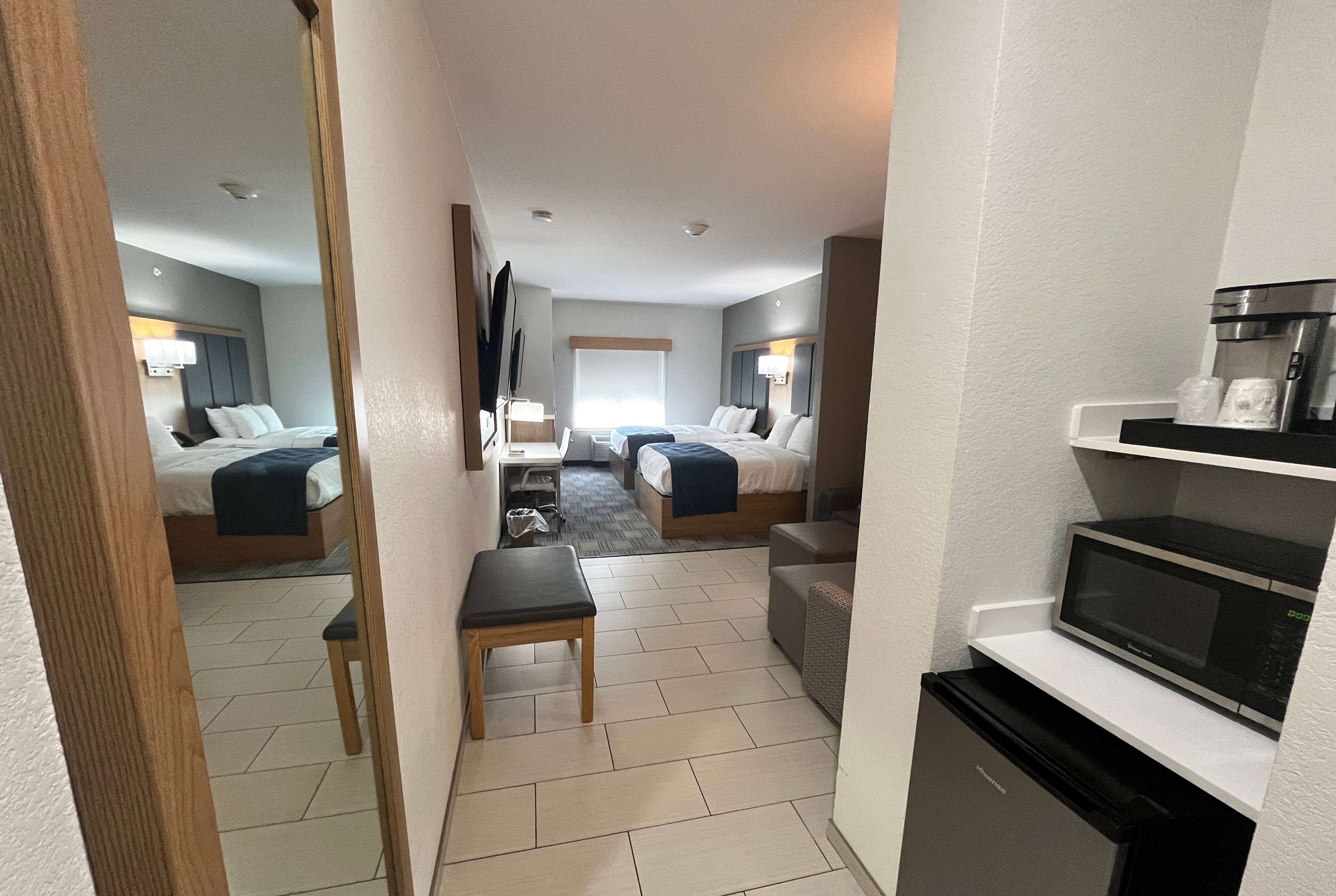 suite, multiple beds (2 tvs) | desk, laptop workspace, iron/ironing board, bed sheets