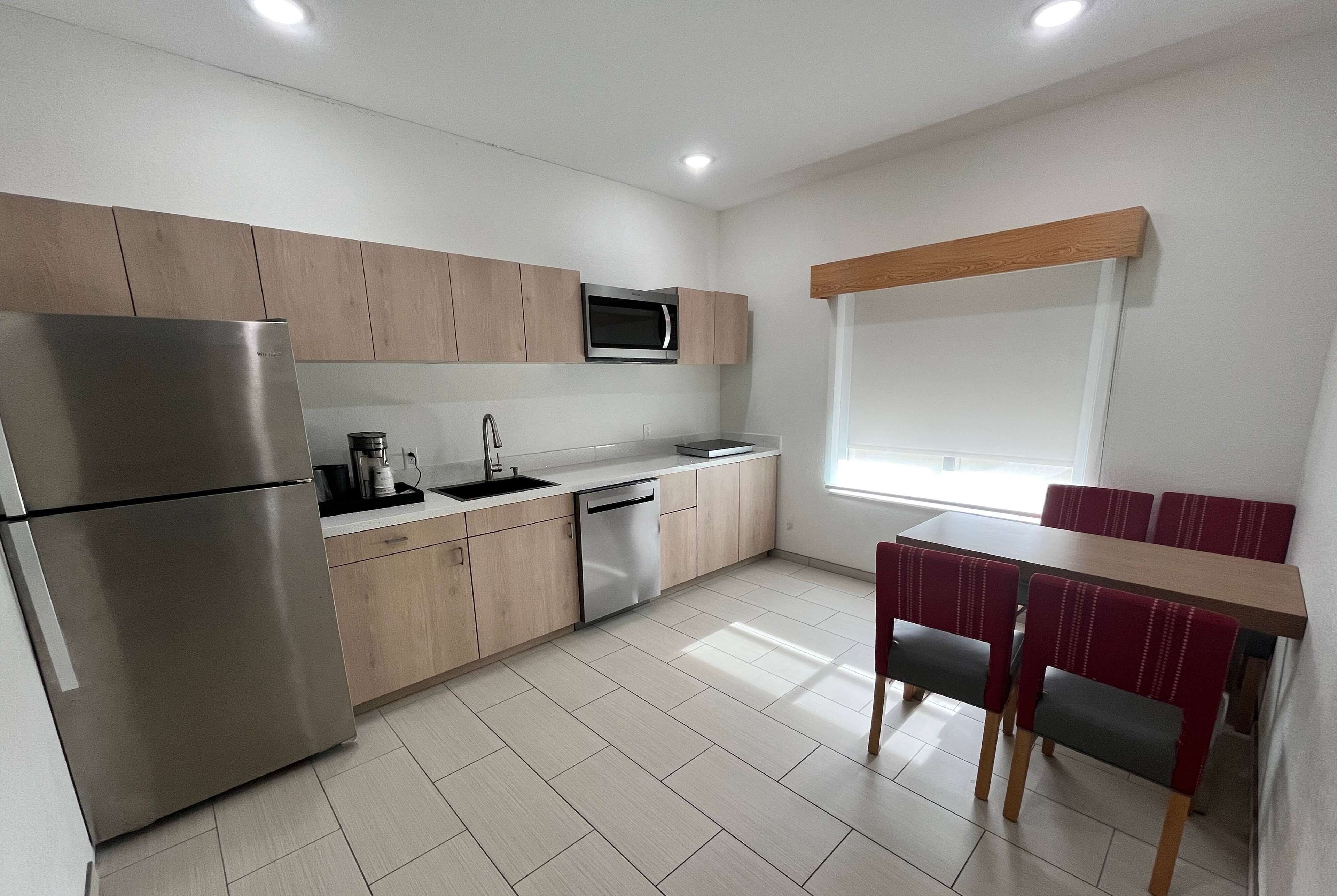 desk, laptop workspace, iron/ironing board, bed sheets