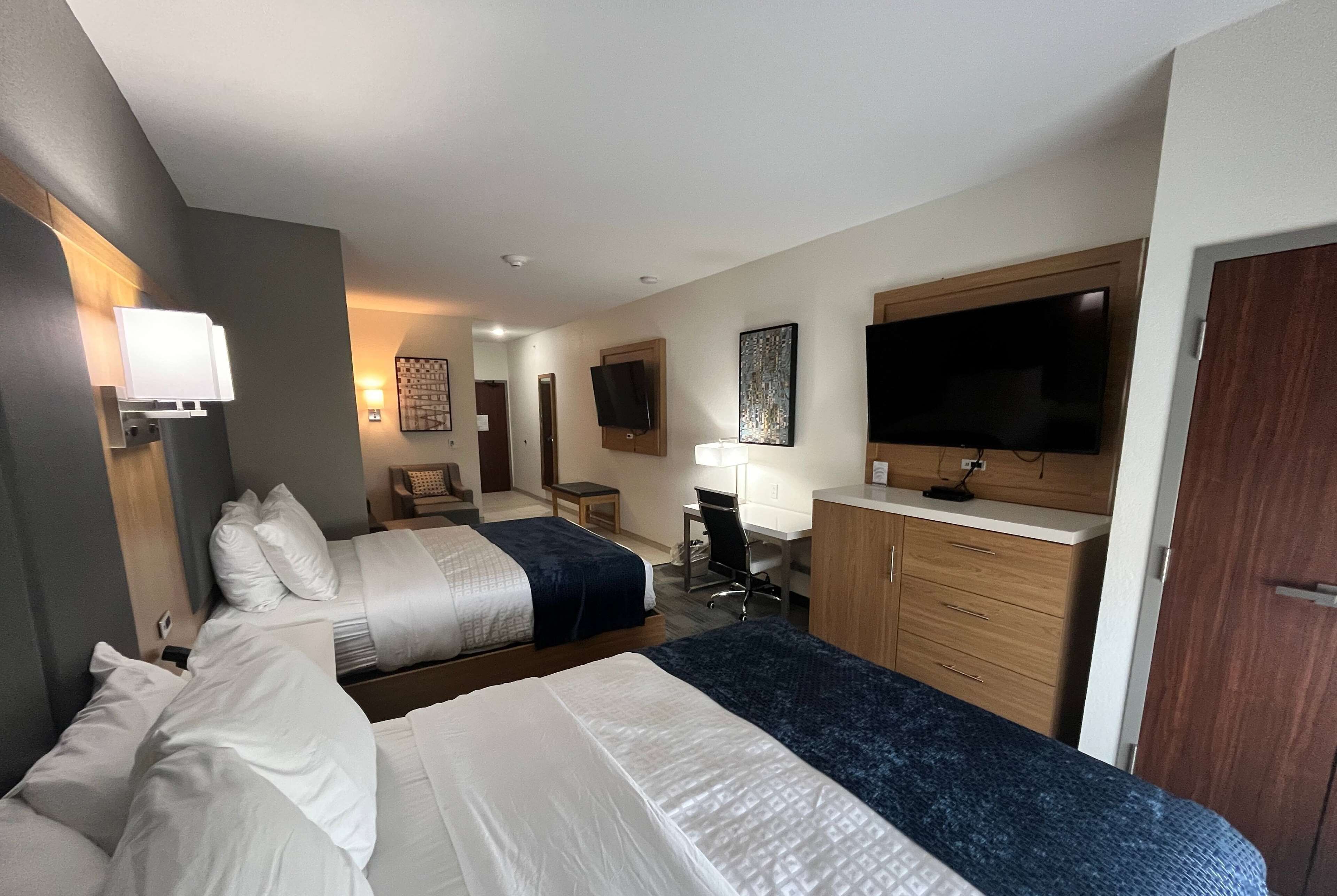 suite, multiple beds (2 tvs) | desk, laptop workspace, iron/ironing board, bed sheets