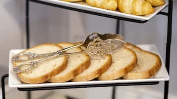 Ein Tablett mit Croissants und ein Korb mit verschiedenen Brotsorten.