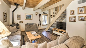 A cozy living room with a wooden ceiling, a staircase, and a TV. - 3 Mi to Lake Tahoe: Quiet Incline Village Cabin! (Incline Village)