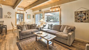 A cozy living room with two sofas, a coffee table, and wooden flooring. - 3 Mi to Lake Tahoe: Quiet Incline Village Cabin! (Incline Village)