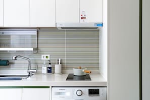 Fridge, microwave, coffee/tea maker, cookware/dishes/utensils