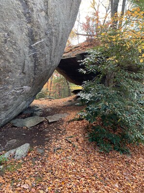 A natural rock formation with a path leading through it.