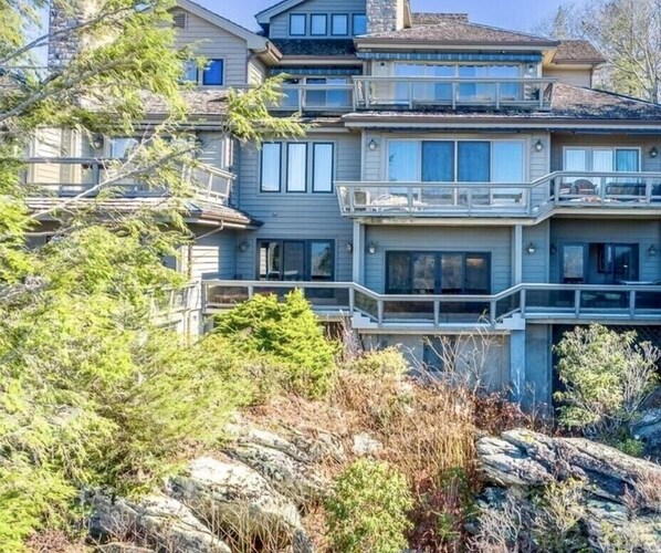 A multi-story house with a balcony on the second floor.