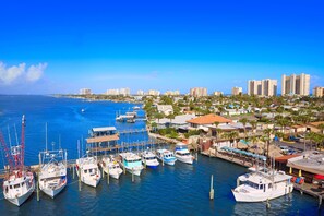 Boats docked in a bustling marina surrounded by a charming coastal town.