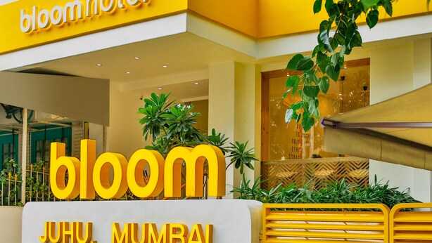 A hotel entrance with a prominent 'bloom' sign and 'JUHU, MUMBAI' text. - Bloom Hotel Juhu (Mumbai)
