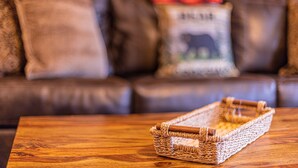 A wicker tray on a wooden table with a brown leather couch in the background. - 6 Cabins with Kitchens+Gameroom&Playground (Payson)