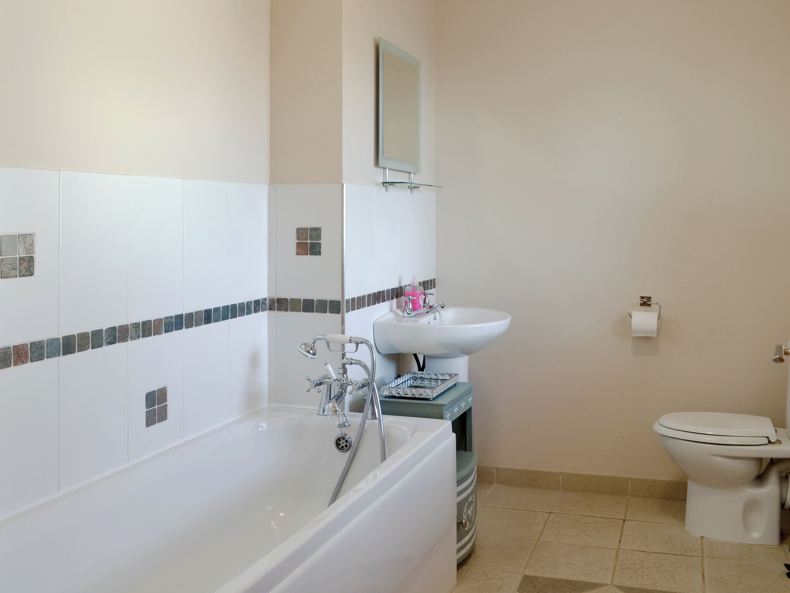 A bathroom with a bathtub, a sink, and a toilet.