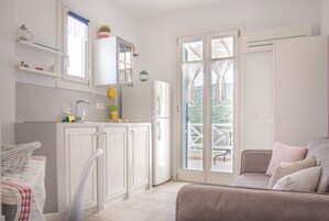 Deluxe Studio Suite, 1 King Bed, Balcony, Partial Sea View | Private kitchen | Fridge, stovetop, coffee/tea maker, electric kettle