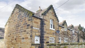 A stone building with a sign reading "STONE ROW". - 2 bedroom accommodation in Skinningrove, near Saltburn-by-the-Sea (Skinningrove, near Saltburn-by-the-Sea)