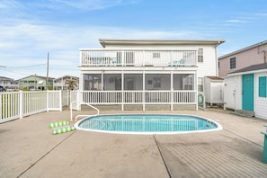 A two-story house with a swimming pool, white railings, and a fenced backyard. - Belair (Up) -  Cherry Grove Channel House with a Pool (North Myrtle Beach)