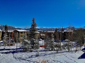A snow-covered landscape with buildings and mountains in the background. - 26/27 El Nino Winter Basecamp! Fully stocked, fresh design, private condo! (Silverthorne)