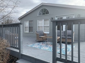 A house with a deck, two wicker chairs, a table, and a patterned rug. - 7006 Gail Sue · ✪☆★✪ Cindy`s Super Ranch Home ✪★☆✪ (West Chester Township)