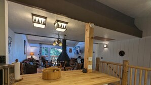 A kitchen with a wooden countertop, a built-in stove, and a hanging light fixture. - Your All-Season Chalet Basecamp – A/C + Unmatched Location! (Big Bear Lake)