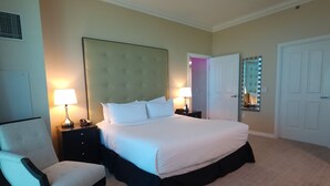 A hotel room with a large bed, two bedside tables, a chair, and a wardrobe. - SuitestayLV~1BR Corner PH Suite/Balcony 31st Floor (Las Vegas)