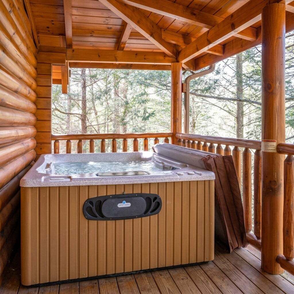 A wooden cabin with a hot tub on a deck.