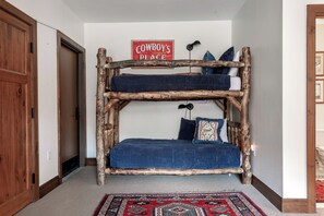 A bunk bed made of logs with a 'Cowboy's Place' sign above it. - Charlie Rentz: Bachelor Gulch Ski-In/Out, Sleeps 12, Ritz Pool + Hot Tub Access, 2 King Suites (Avon)