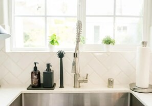 Bathtub, hair dryer, towels, shampoo