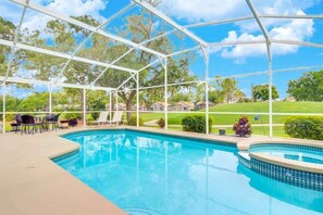 A covered outdoor swimming pool with a clear view of the surrounding landscape.