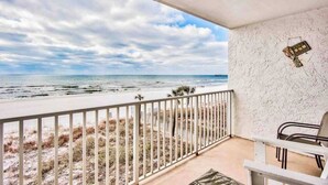 Un balcon avec vue sur la plage et l’océan.