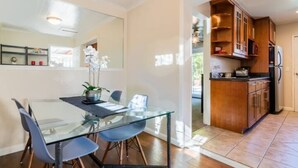 A modern kitchen with wooden cabinets and a built-in oven. - Modern poolside house with AC Downtown Mountain View! (Mountain View)