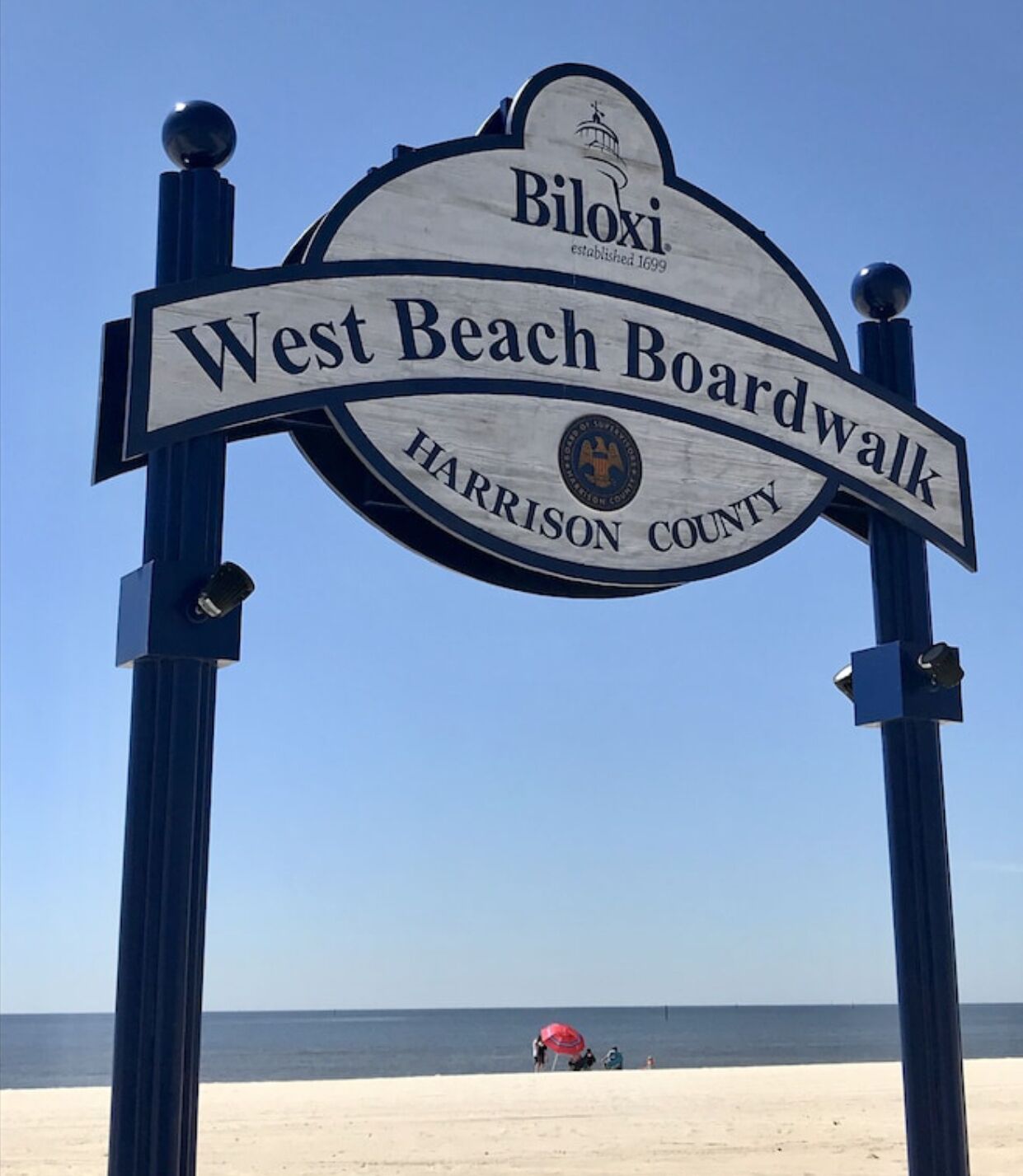 A sign for West Beach Boardwalk in Harrison County, established in 1699.