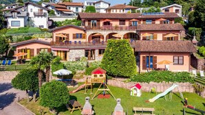Uma área residencial com várias casas, um parquinho e um caminho pavimentado.