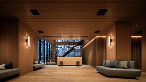 A spacious lobby with a wooden floor, a reception desk, and a staircase leading to upper floors. - Bespoke Hotel Sapporo (Sapporo)