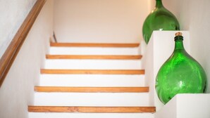 A staircase with wooden steps and green glass bottles placed on the right side.