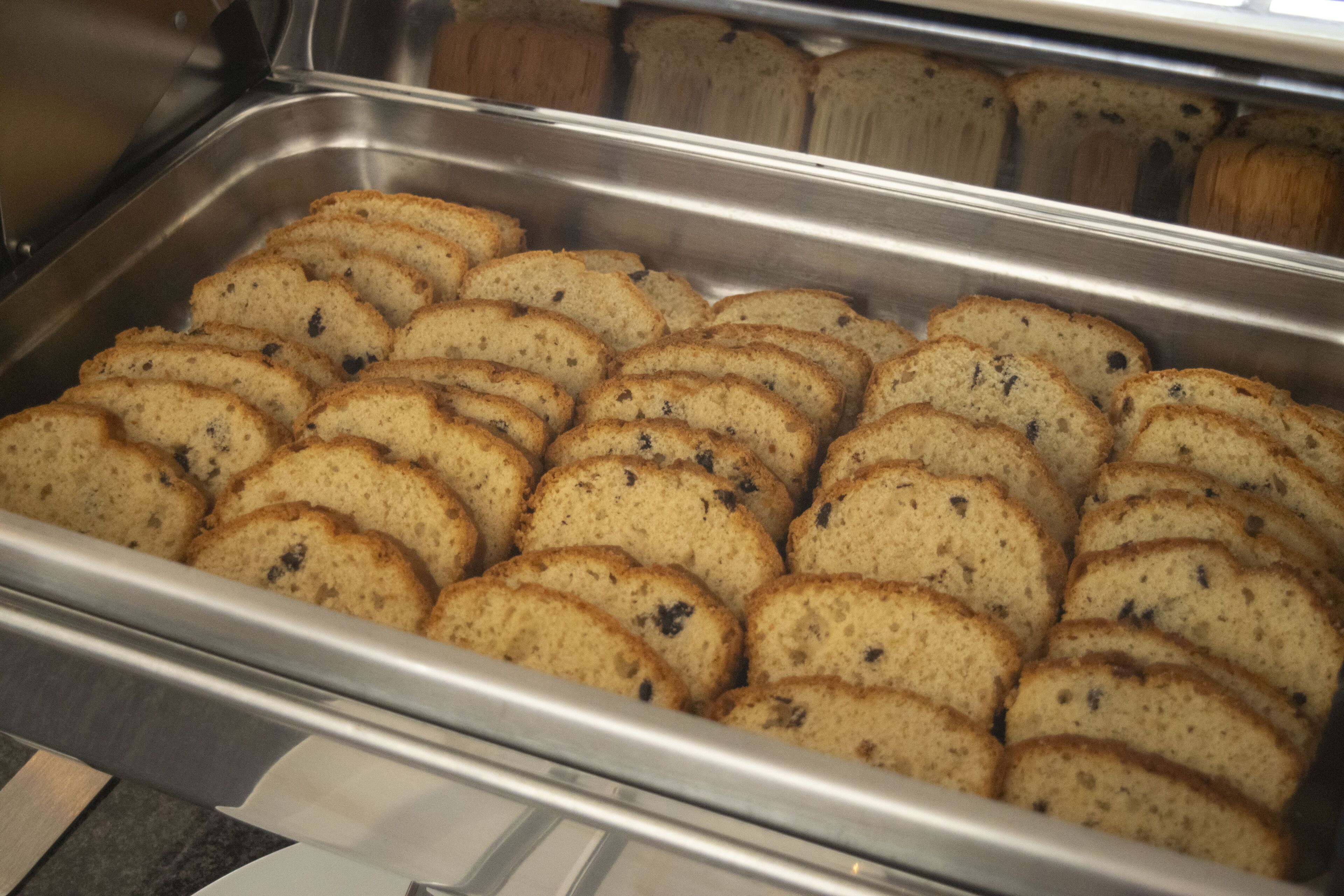 A metal tray filled with sliced bread.