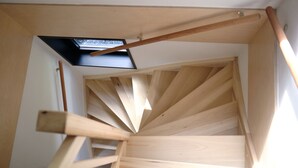 A wooden spiral staircase with a skylight above. - Luxury Lodge With Roof Terrace, Near Maastricht (Gulpen)