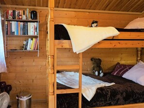 A bunk bed room with a wooden bookshelf, a teddy bear, and a fan. - 4 Person Holiday Home in Tibro (Tibro)