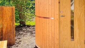 A wooden shed with a door, a window, and a metal handle. - 4 Person Holiday Home in Tibro (Tibro)