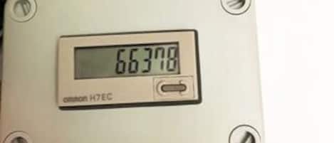 A digital thermostat with the temperature reading of 66.378.