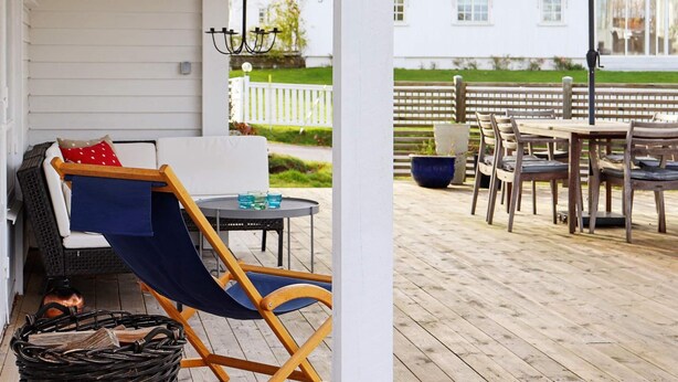 A covered porch with a seating area, a table, and outdoor furniture. - 5 Person Holiday Home in Varobacka (Väröbacka)
