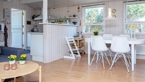 A modern kitchen with white cabinetry, a central island, and pendant lighting. - 4 Person Holiday Home in Thisted (Thisted)