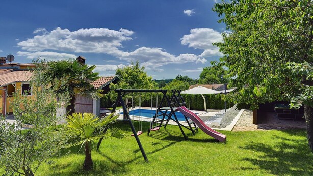 A backyard with a swing set, a slide, and a swimming pool. - Holiday Home in Lindar With Pool (Pazin)