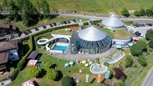 Un resort con piscina, area esterna coperta e parcheggio.