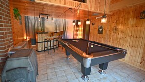 A pool table in a room with wooden walls and a brick fireplace. - Chalet in Beffe With Hot Tub & Valley Views (Rendeux)