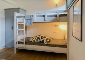 A bunk bed with a ladder, a pillow, a cabinet, and a wall-mounted light fixture. - Chalet Retreat With Sauna in Wald (Wald im Pinzgau)