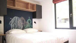 A bed with white bedding, a wooden headboard, and a wall mural. - Detached Lodge Near Maastricht (Gulpen)