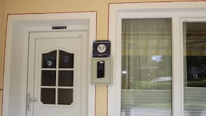 A door with a sign indicating a guest review score of 9.7, a keypad lock, and a window with blinds. - Apartment in Seefeld Near Rosshutte Ski Resort (Seefeld in Tirol)