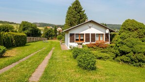 A single-story house with a sloped roof, a chimney, and a satellite dish. - Ideal Holiday Home in Wutha-Farnroda near City Center (Wutha-Farnroda)